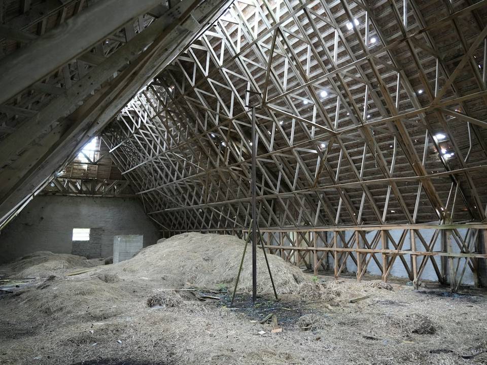 Large attic with loose fill insulation on the floor